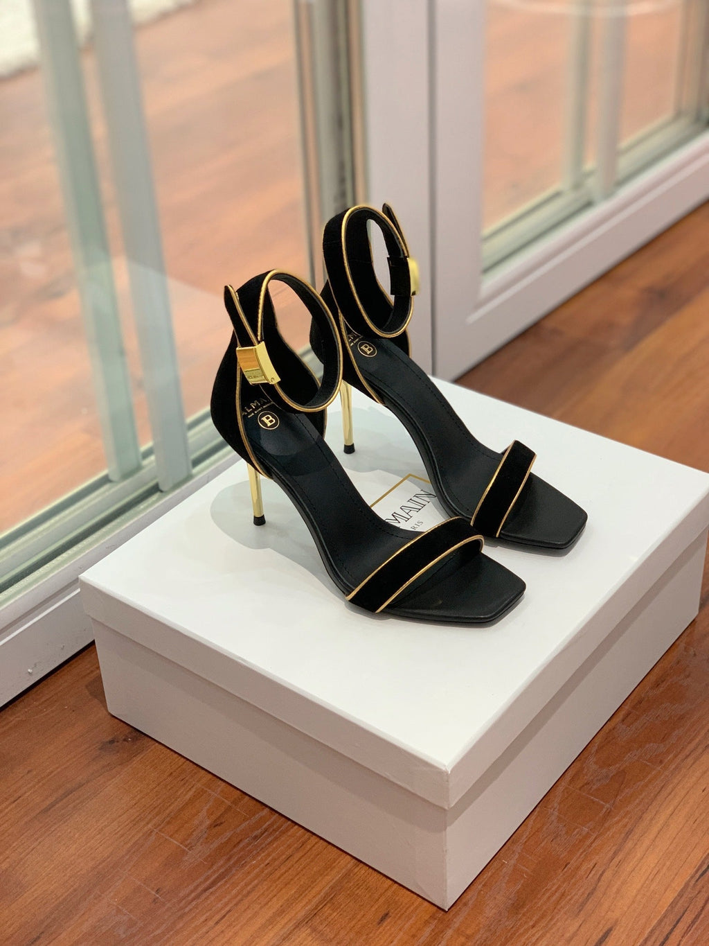 BALMAIN 25S UMA HEELED SANDALS 105MM IN BLACK SUEDE GOLD HARDWARE