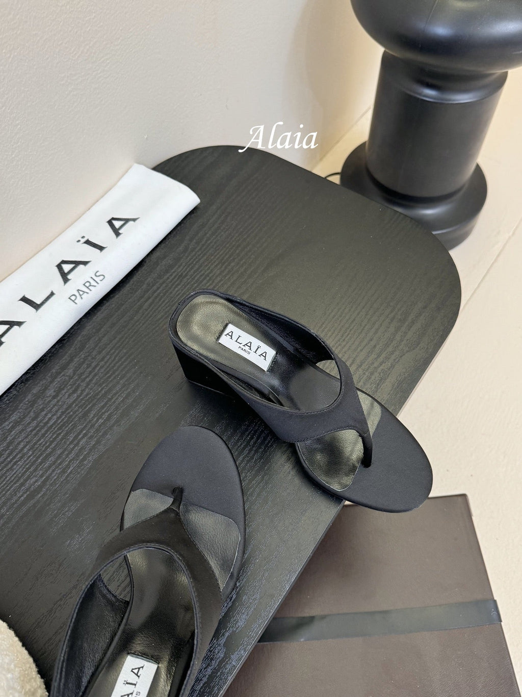 ALAIA WEDGE THONG SANDALS 25S IN BLACK SATIN