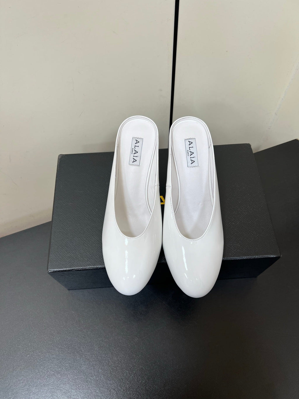 ALAIA WEDGE MULES 25S IN CREAM WHITE LAMBSKIN