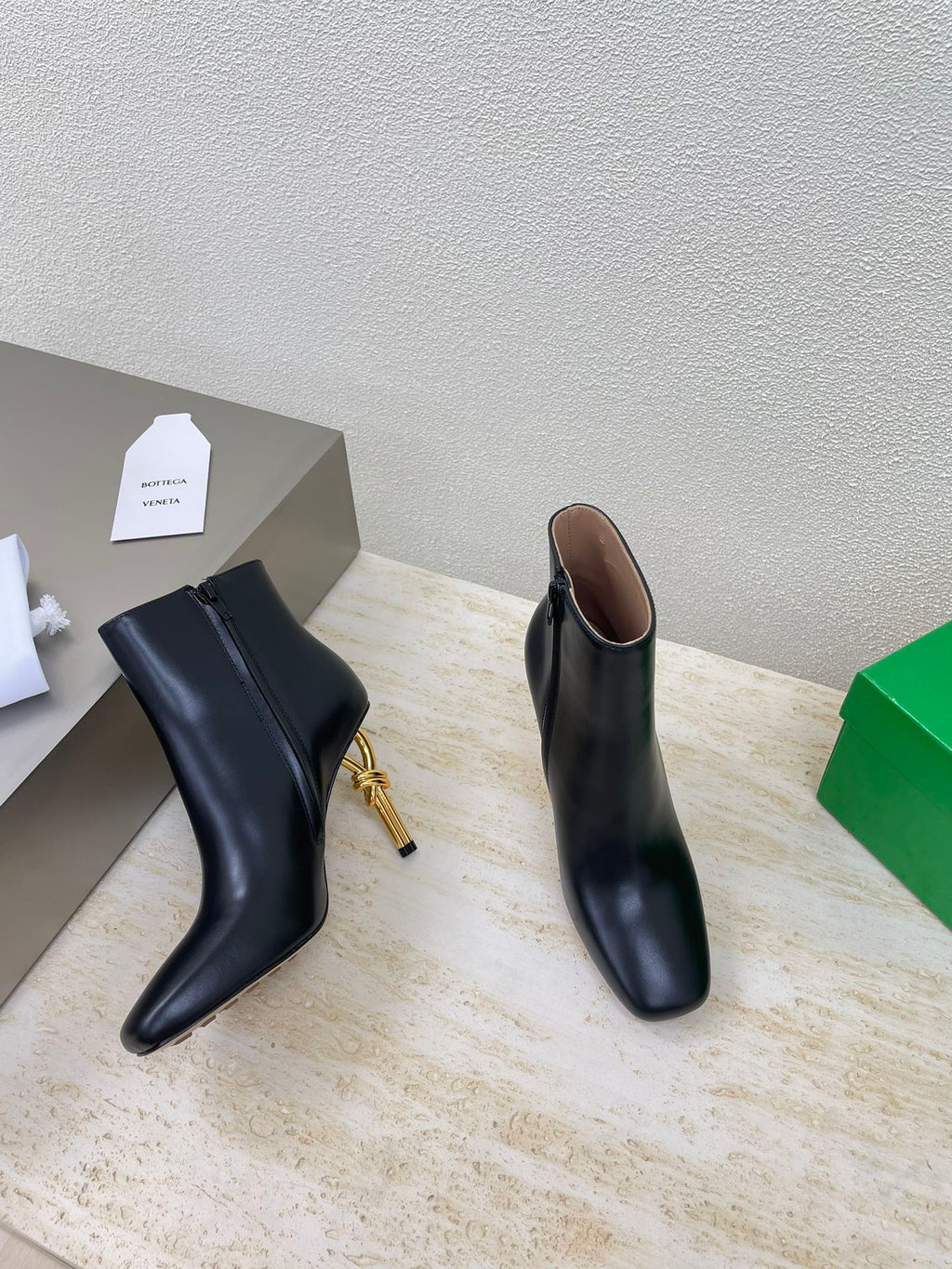 BOTTEGA VENETA KNOT ANKLE BOOT IN BLACK CALFSKIN WITH GOLD METAL HEEL 9 CM