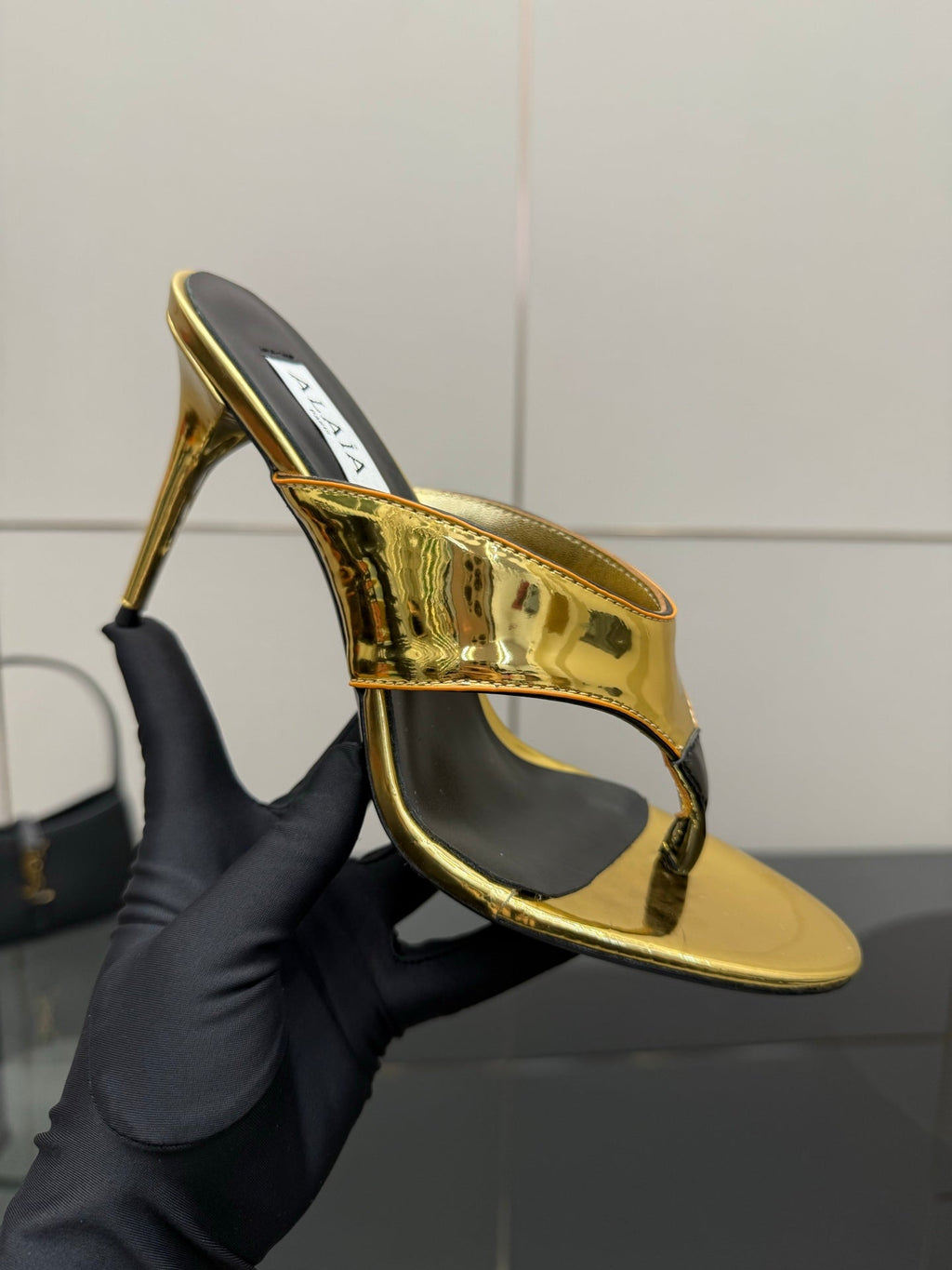 ALAIA HEELED THONG 25S IN GOLD PATENT LEATHER